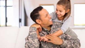 Soldier smiling with his daughter