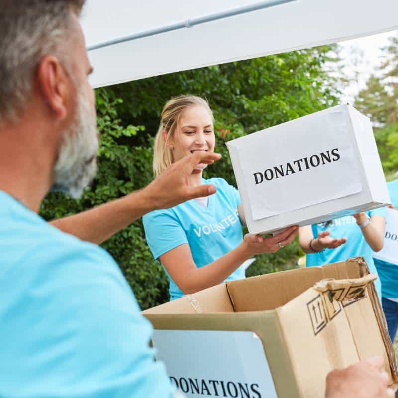 Community service volunteers handling donations